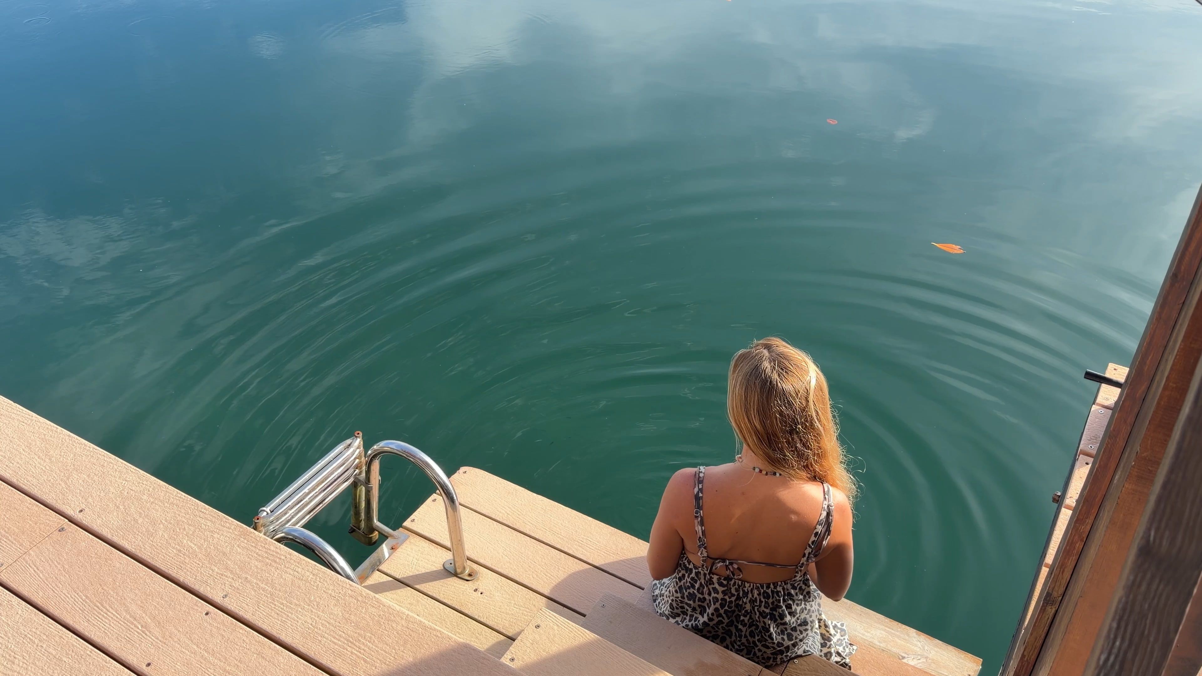 Someone sitting on the steps that go down to the water