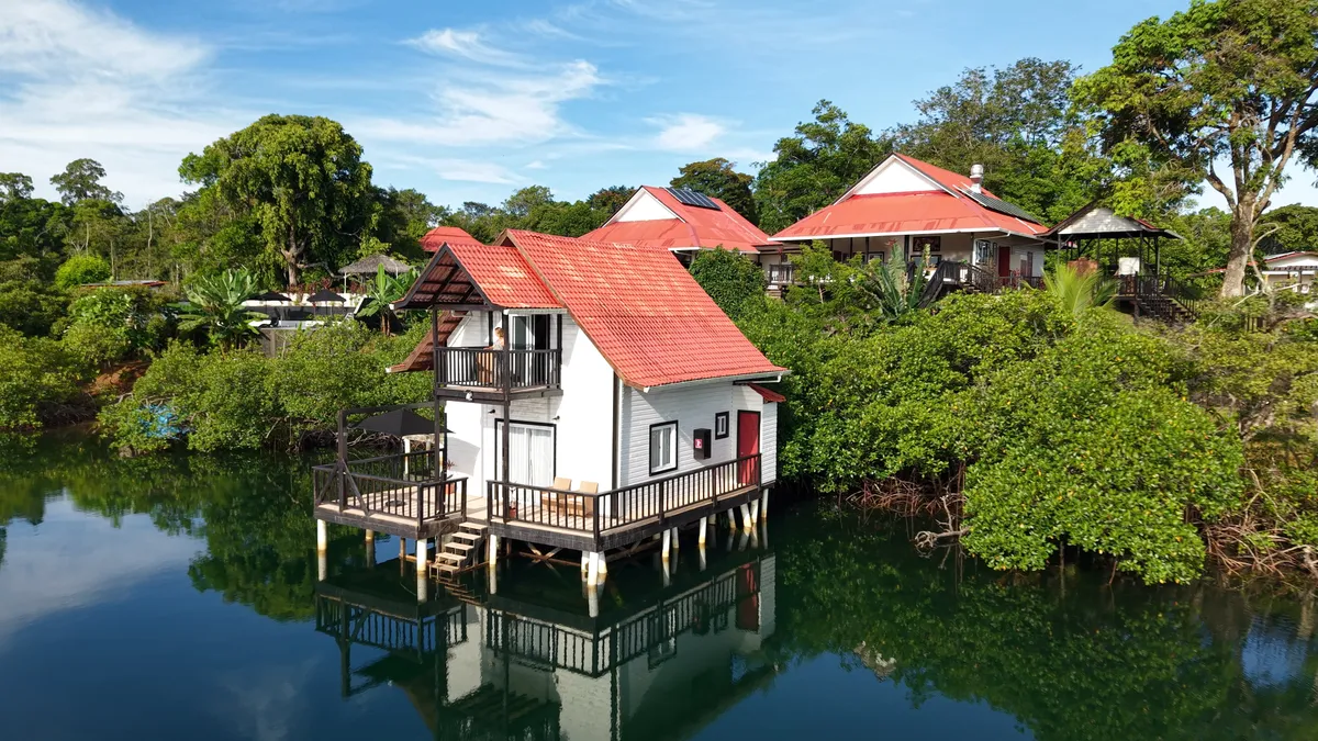 Casa del Mar and its reflection in the lagoon, among the mangroves