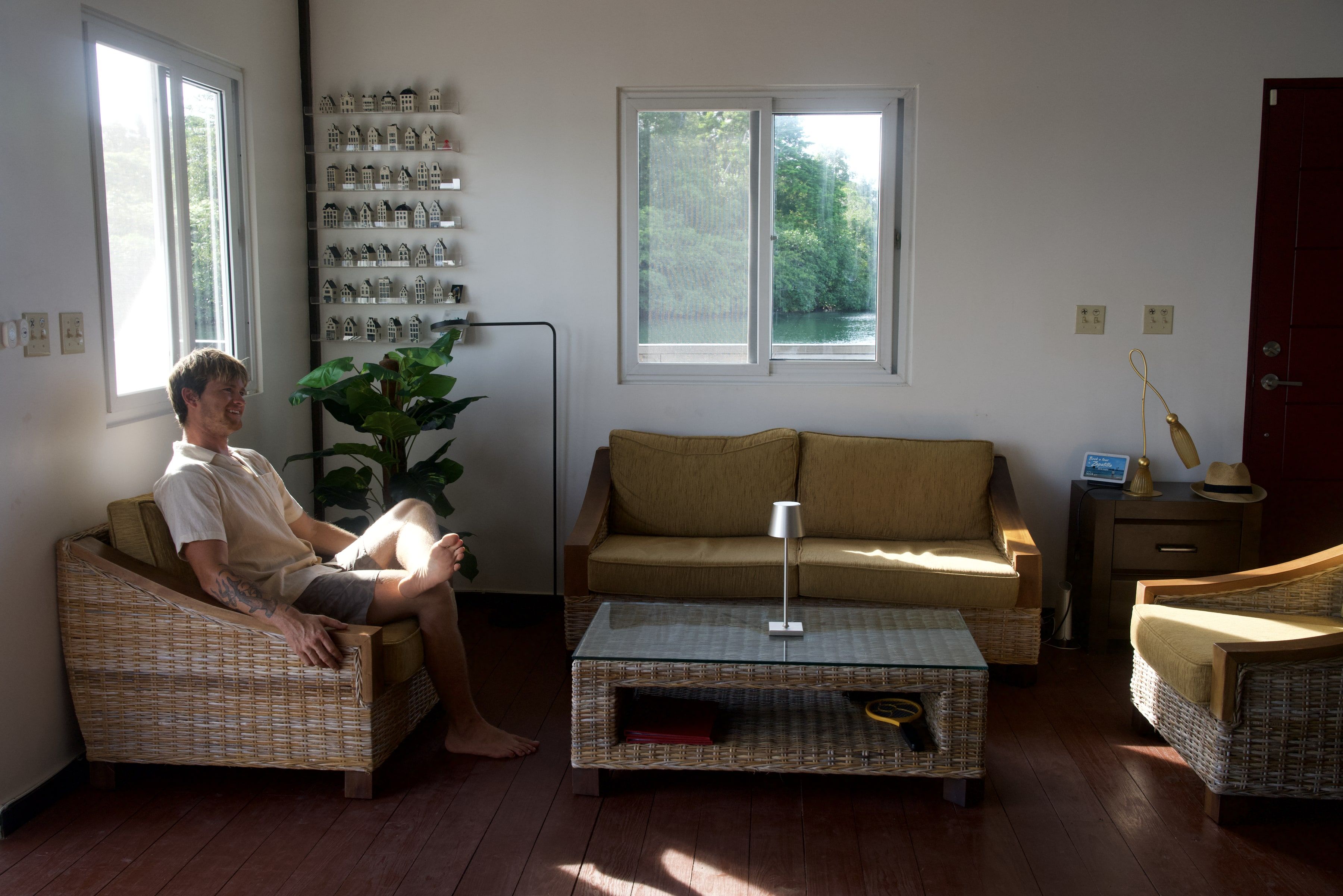 The living room, with someone in an armchair by the window