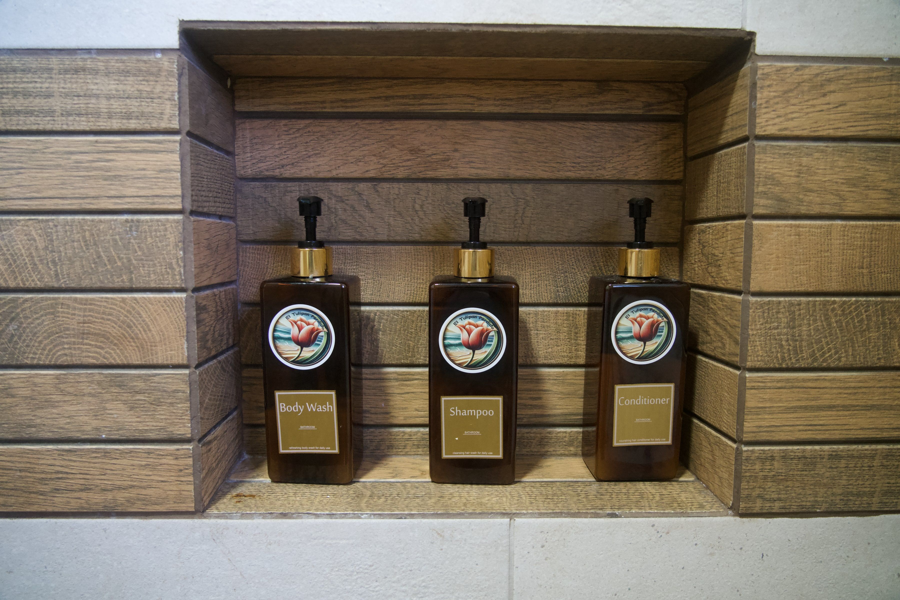 Body wash, shampoo and conditioner in a niche in the bathroom