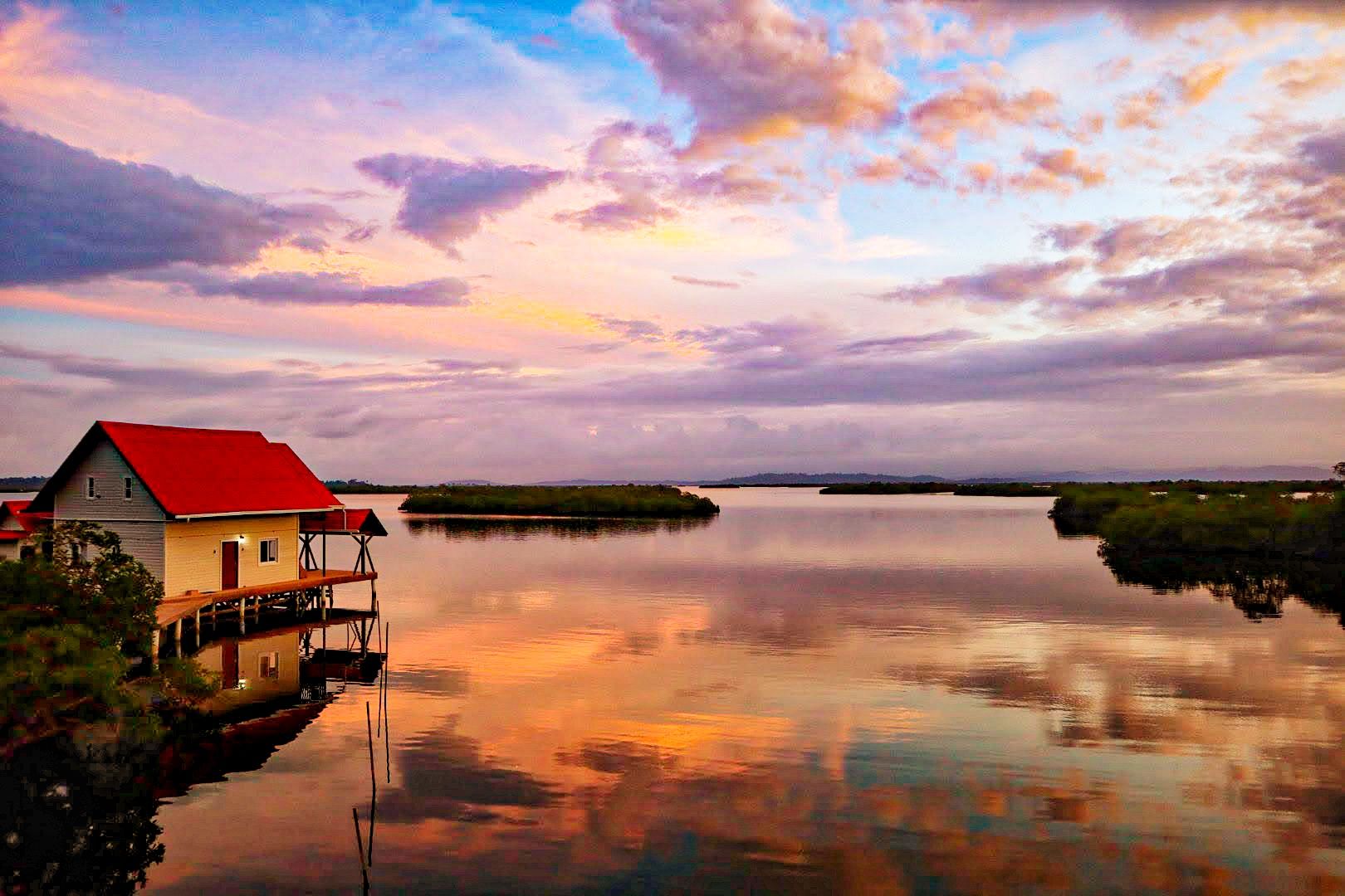 The lagoon at sunset, with the bungalow at the edge of the mangroves