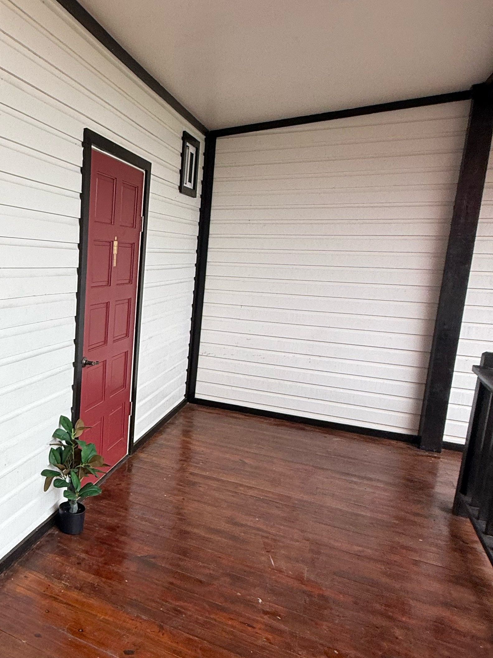 The door to the Orchid Lounge restrooms, on the wooden deck