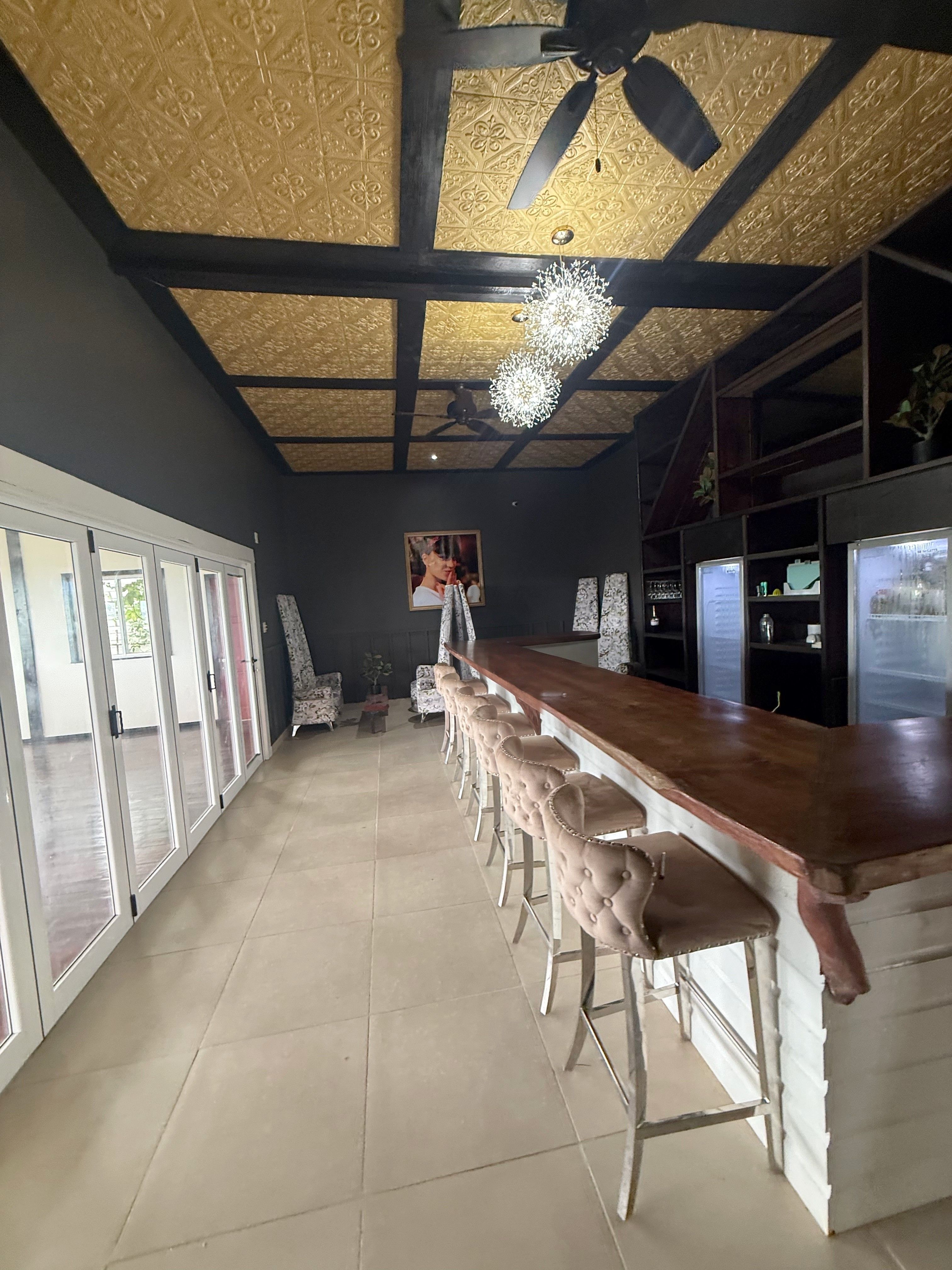 The long bar counter in the Orchid Lounge, with its upholstered high stools
